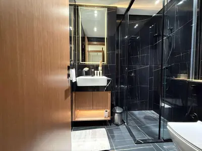 a bathroom with a sink and a shower at Sky High Premium 1BR with Stunning Views in Dubai