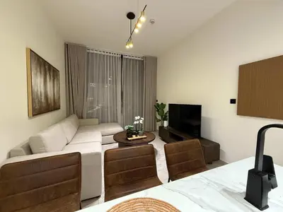 a living room with a couch and a tv at Sky High Premium 1BR with Stunning Views in Dubai