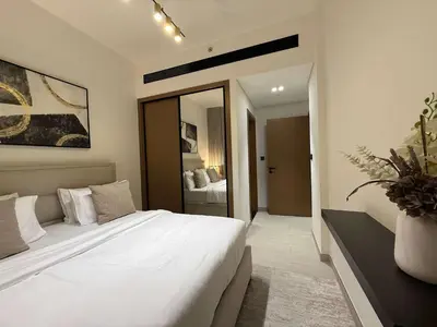 a bedroom with a large white bed and a mirror at Sky High Premium 1BR with Stunning Views in Dubai