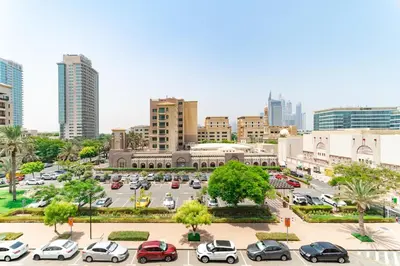 a city with cars parked in a parking lot at Stunning 3BDR in Al Sidir Greens in Dubai