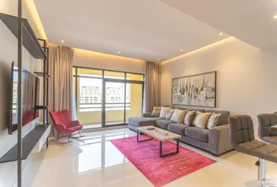 a living room with a couch and a table at Stunning 3BDR in Al Sidir Greens in Dubai