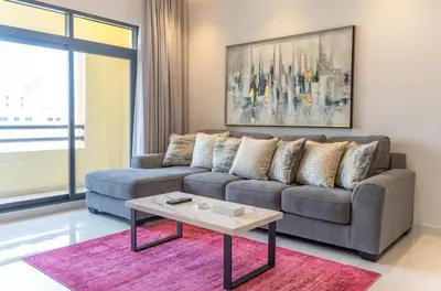 a living room with a couch and a table at Stunning 3BDR in Al Sidir Greens in Dubai