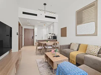a living room with a couch and a table at Aesthetic Elegance 1BDR in Binghatti Onyx in Dubai