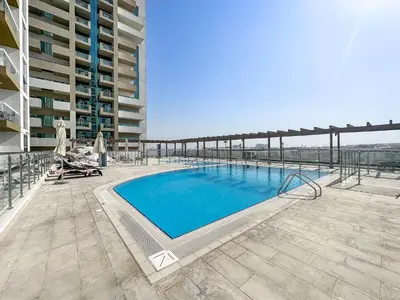 a swimming pool on the roof of a building at Modern Studio In Al-Furjan close to Metro-15 in Dubai
