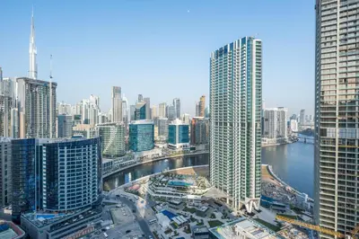 a view of a city with tall buildings and a river at 2 Bedroom in Peninsula with Burj View in Dubai