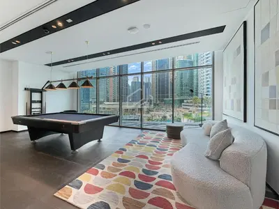 a living room with a pool table and a couch at 2BD Stylish Apartment with Amazing Canal Views in Dubai