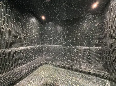 a bathroom with a bath tub with tiled walls at 2BD Stylish Apartment with Amazing Canal Views in Dubai