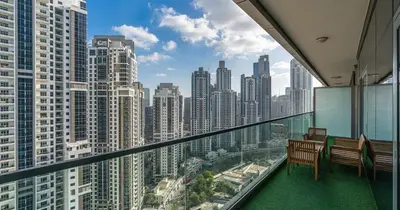 a balcony with two benches and a view of a city at Burj View 2BHK Downtown Infinity Pool in Dubai