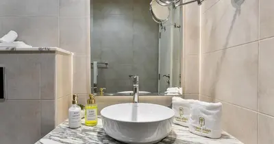 a bathroom with a bowl sink on a counter at Burj View 2BHK Downtown Infinity Pool in Dubai