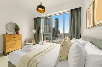 a bedroom with a large bed with a large window at Silkhaus Elite 3BR near Dubai Watercanal in Al Wasl in Dubai