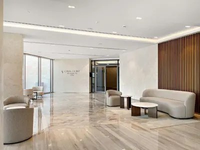 a lobby with chairs and tables in a building at Silkhaus Elite 3BR near Dubai Watercanal in Al Wasl in Dubai