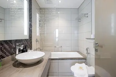 a white bathroom with a tub and a sink at PNB Living - Luxury 2 Bedroom Apartment with High Floor - DAMAC Towers by Paramount Tower D in Dubai