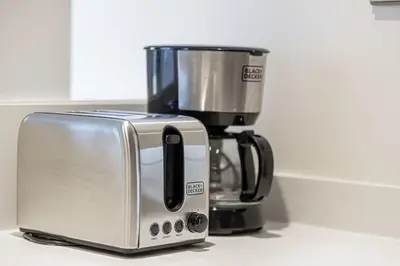 a toaster sitting next to a coffee maker on a counter at PNB Living - Luxury 2 Bedroom Apartment with High Floor - DAMAC Towers by Paramount Tower D in Dubai