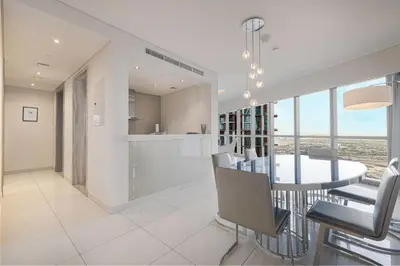 a dining room and kitchen with a table and chairs at PNB Living - Luxury 2 Bedroom Apartment with High Floor - DAMAC Towers by Paramount Tower D in Dubai