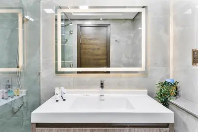 a bathroom with a white sink and a mirror at Beautiful 2BR at Majestique Residence Dubai South in Dubai