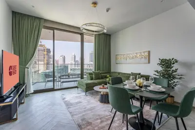 a living room with a couch and a table at GuestReady - 1BR l Burj Khalifa View in Dubai