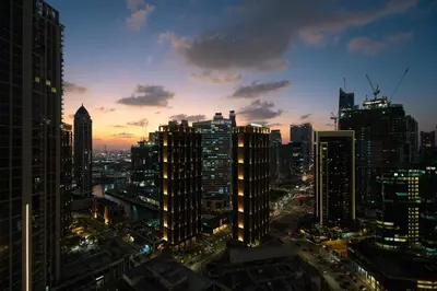 a view of a city skyline at night at GuestReady - 1BR l Burj Khalifa View in Dubai