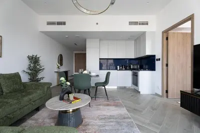 a living room with a couch and a table at GuestReady - 1BR l Burj Khalifa View in Dubai