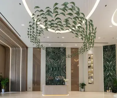 a large chandelier in a hotel lobby with plants at Stylish 1BR at Binghatti Phantom with Private Pool in Dubai