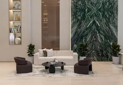 a living room with a white couch and two chairs at Stylish 1BR at Binghatti Phantom with Private Pool in Dubai