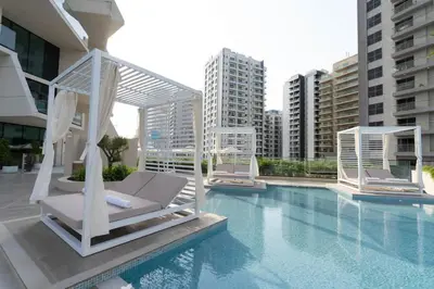 a hotel swimming pool with a whitevisorvisorvisorvisorvisorvisor at Stylish 1BR at Binghatti Phantom with Private Pool in Dubai