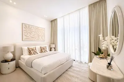 a white bedroom with a bed and a large window at Stylish 1BR at Binghatti Phantom with Private Pool in Dubai