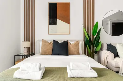 a bedroom with a large white bed with two pillows at Silkhaus Studio Stay in Dubai Marina - Botanica in Dubai