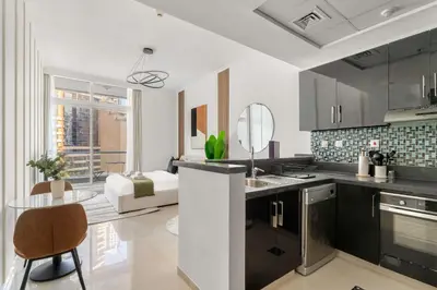 a kitchen with a sink and a table in a room at Silkhaus Studio Stay in Dubai Marina - Botanica in Dubai