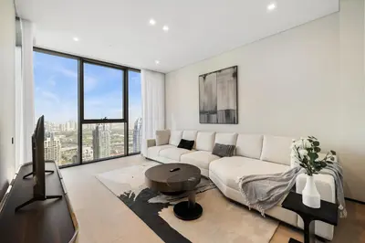 a living room with a white couch and a tv at LIV Marina, Dubai Marina - 4 Bedroom Penthouse with Panoramic Views - Allsopp & Allsopp in Dubai