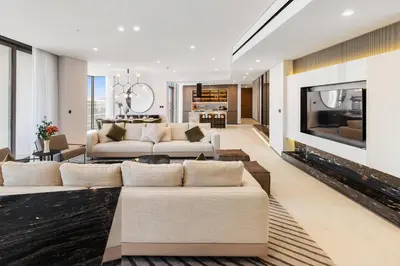 a living room with two couches and a fireplace at LIV Marina, Dubai Marina - 4 Bedroom Penthouse with Panoramic Views - Allsopp & Allsopp in Dubai