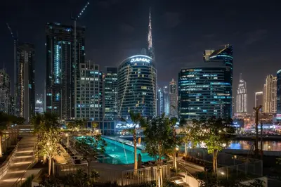 a city skyline at night with a swimming pool at GuestReady - Premium Location | Studio | Pool View in Dubai