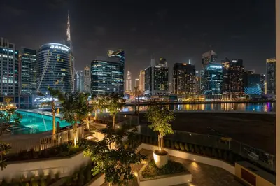 a view of a city skyline at night at GuestReady - Premium Location | Studio | Pool View in Dubai