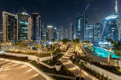 a city skyline at night with tall buildings at GuestReady - Premium Location | Studio | Pool View in Dubai