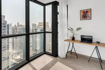 an office with a desk and large windows at Scenic Lakeview Stay Stylish 1 Bedroom in JLT in Dubai