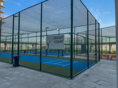a batting cage with a tennis court in it at Chic Studio near Dubai Miracle Garden & Expo City in Dubai