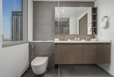 a bathroom with a toilet and a sink at Daniels 2BR at Creek Gate with Canal View in Dubai