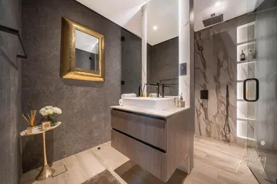 a bathroom with a sink and a mirror at 1BR Sunlit Modern Retreat with Private Sunbeds in Dubai