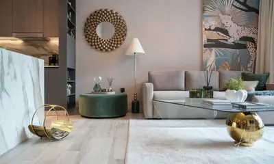 a living room with a couch and a table at 1BR Sunlit Modern Retreat with Private Sunbeds in Dubai