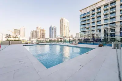 a swimming pool in the middle of a building at Well-Appointed Studio, Minutes from Circle Mall and Community Parks - Binghatti Phoenix, Jumeirah Village Circle by Deluxe Holiday Homes in Dubai