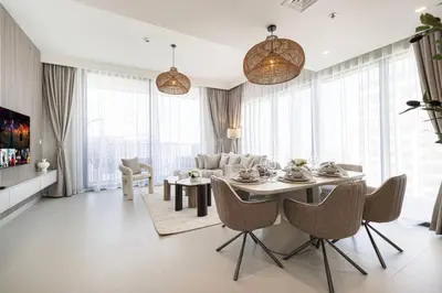 a living room with a table and a couch at Mahogany 26 - 4BR 9PAX - Dubai Hills Park Peaceful in Dubai