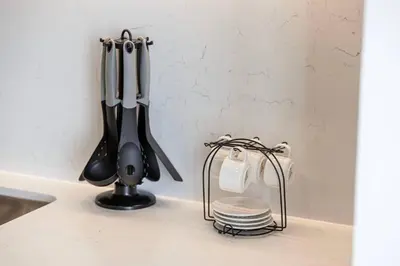 a kitchen counter with utensils on a counter top at Mahogany 26 - 4BR 9PAX - Dubai Hills Park Peaceful in Dubai