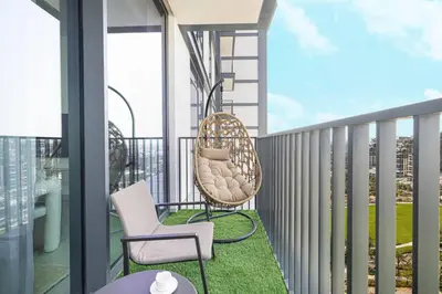 a balcony with chairs and a table on a building at Mahogany 26 - 4BR 9PAX - Dubai Hills Park Peaceful in Dubai