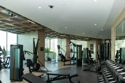 a gym with treadmills and exercise equipment in a building at Spacious and Cozy Apartment - Binghatti Phantom 2404 in Dubai