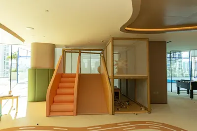 a house with an orange staircase in a room at Spacious and Cozy Apartment - Binghatti Phantom 2404 in Dubai