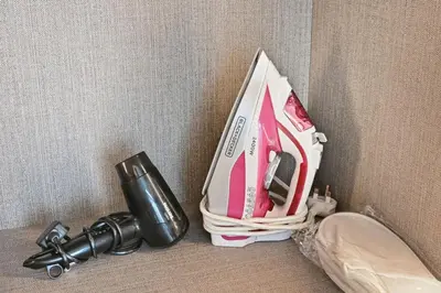 a bag is sitting on the floor next to a sink at Luxury 1BR at Royal Regency, Refined City Living in Dubai