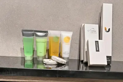 a group of four differentiallypriced products on a counter at Luxury 1BR at Royal Regency, Refined City Living in Dubai