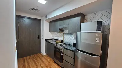 a kitchen with a stainless steel refrigerator and a stove at Bella-Rose-Fully Furnished Cozy High Floor Amazing View in Dubai