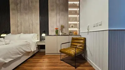 a bedroom with a bed and a chair at Bella-Rose-Fully Furnished Cozy High Floor Amazing View in Dubai