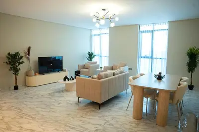 a living room with a couch and chairs and a table at Italian-Design 2BR l Large Private Terrace l Ground Floor in Dubai