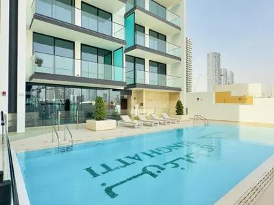 a swimming pool in front of a building at Elegant and Stylish Retreat - Lavender Binghatti 1103 in Dubai